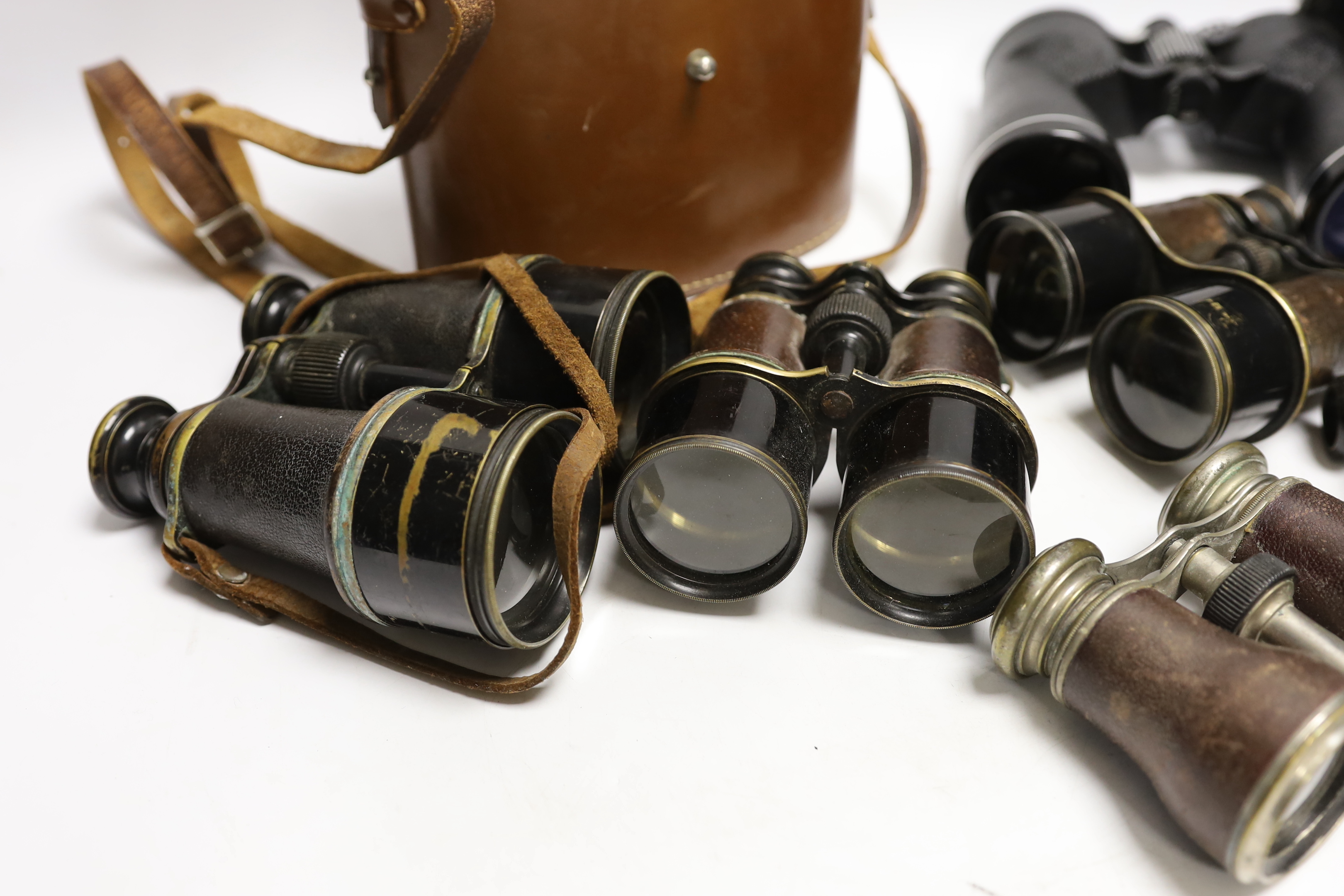 Seven pairs of binoculars including some early 20th century examples, a pair by Ross, etc.